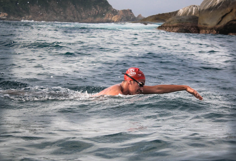 man swimming during daytime