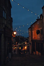 A dimly lit Sicilian village street at dusk, evoking the mood of Verga's stories.