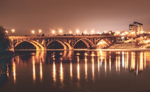 Night view of Bridgewater illuminated, reflecting on the calm river water.