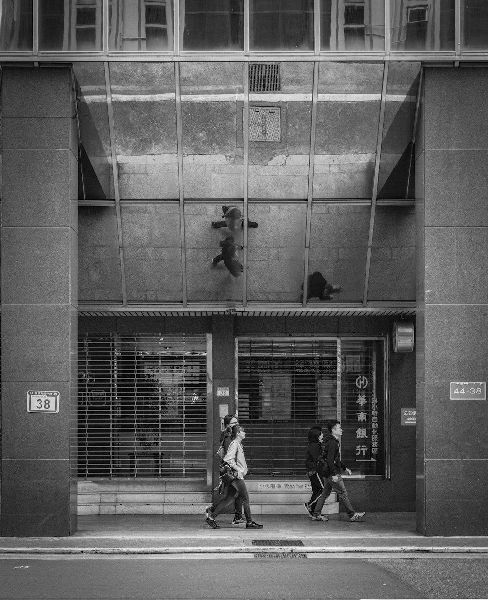 people waking beside building