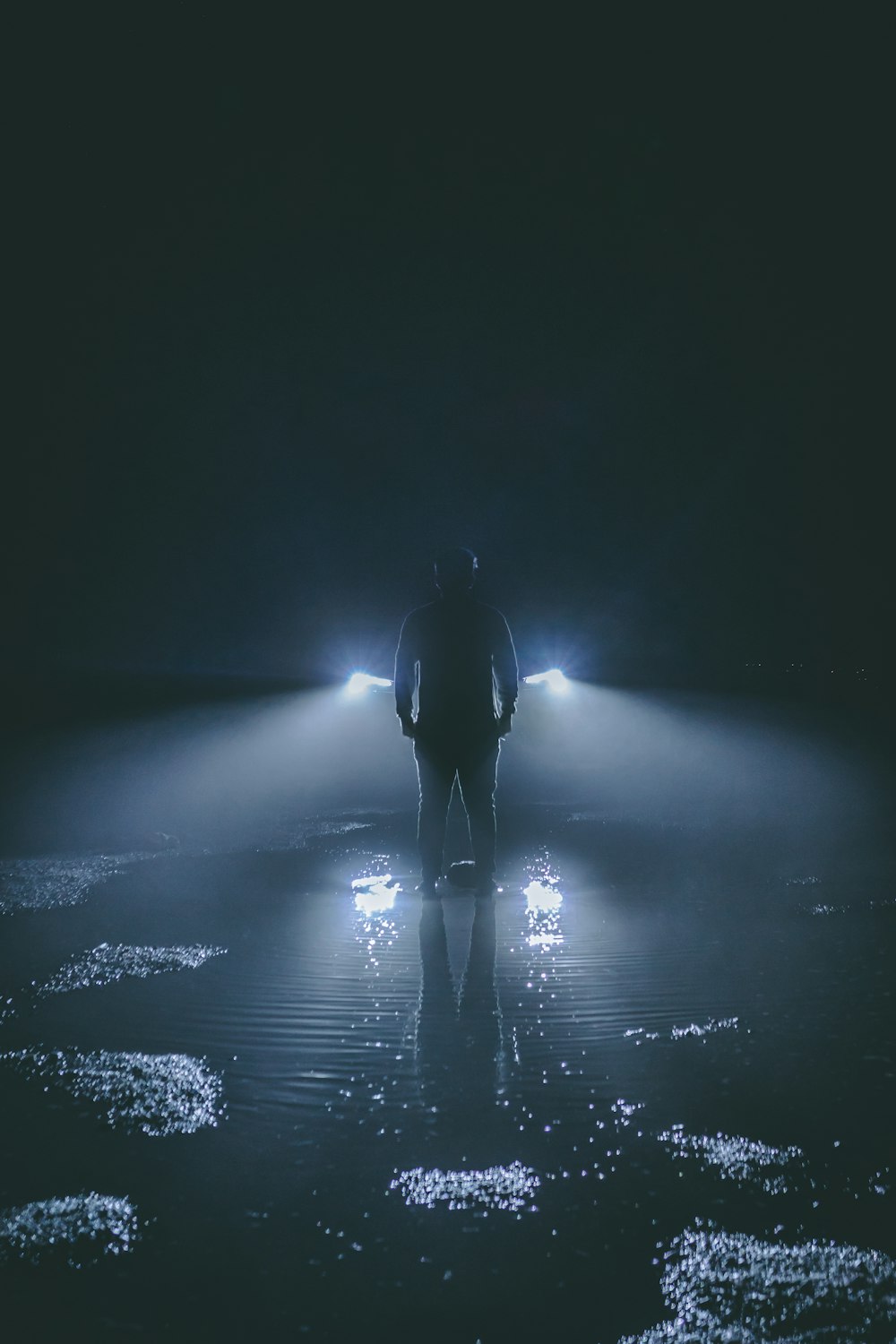 silhouette of person standing near car