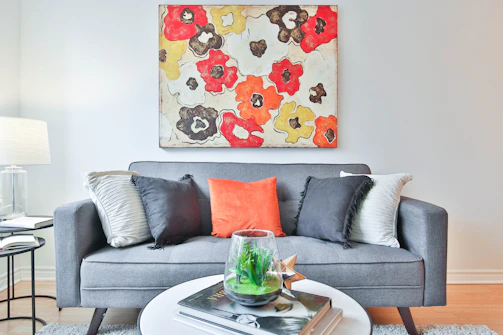 A cozy living room featuring a large framed abstract wall art above a cream sofa.