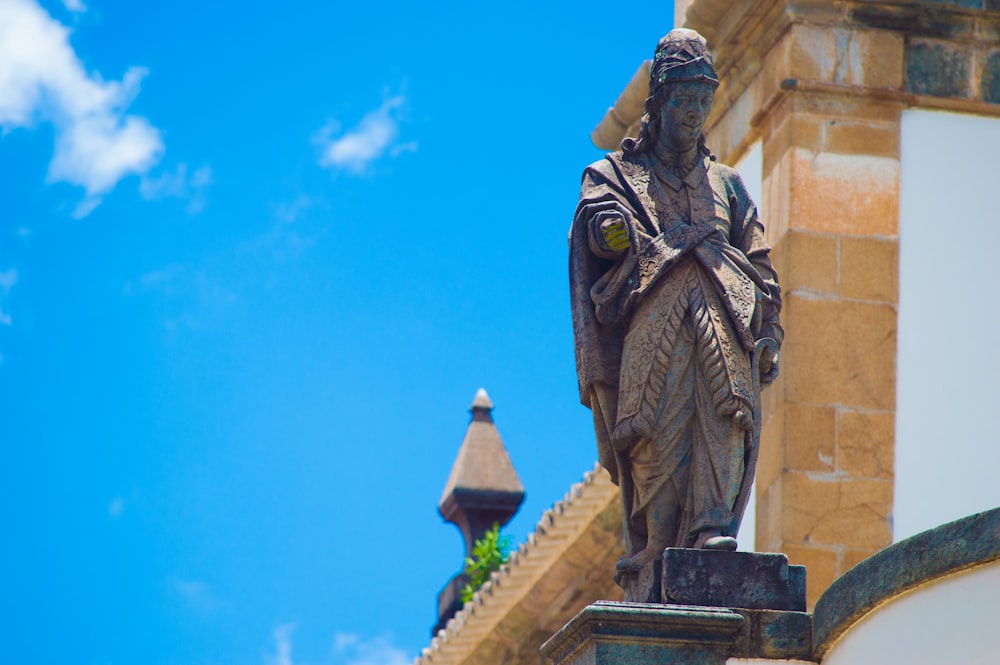 human statue under blue sky at daytime