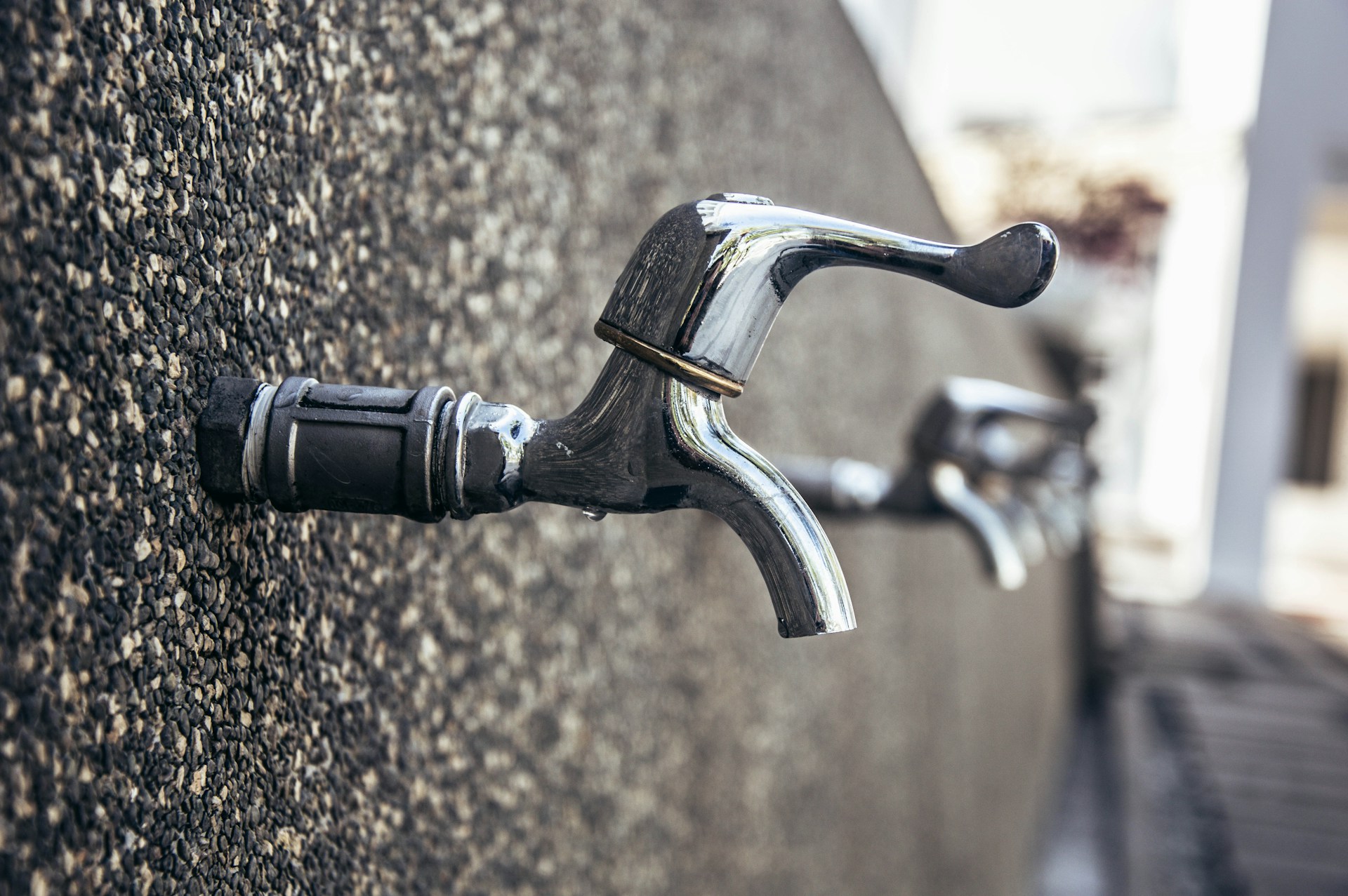 Close-up of a high-quality water mixer with elegant gold handles, highlighting craftsmanship and detail.