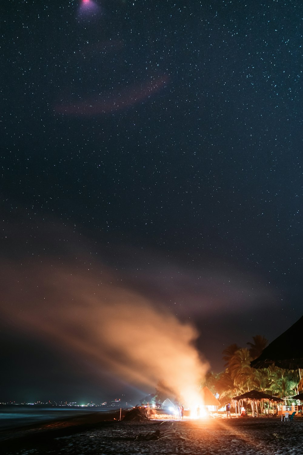 smoke from fire near buildings at nighttime