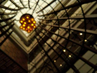 Artistic angle of intersecting metal beams and wooden elements under soft lighting.