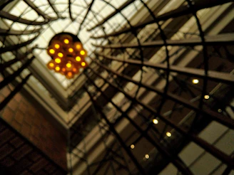 Artistic angle of intersecting metal beams and wooden elements under soft lighting.
