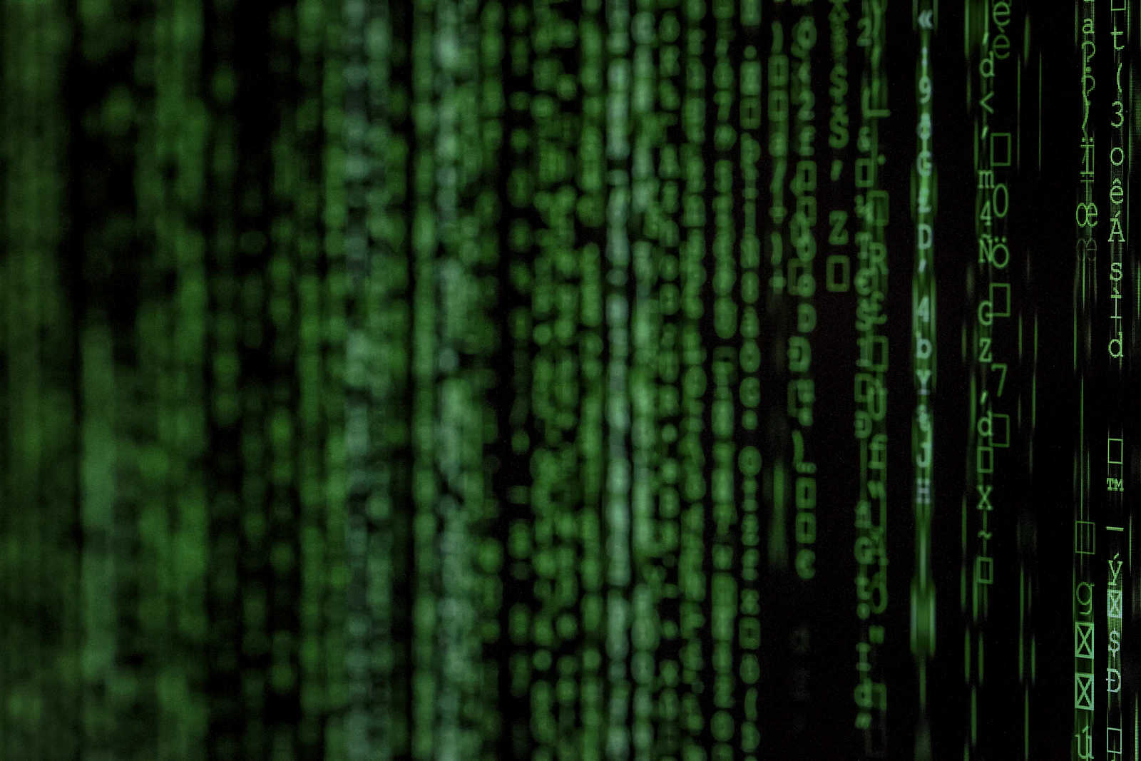 Vertical columns of glowing green digital code, representing the raw server log data crawl budget analysis is built from