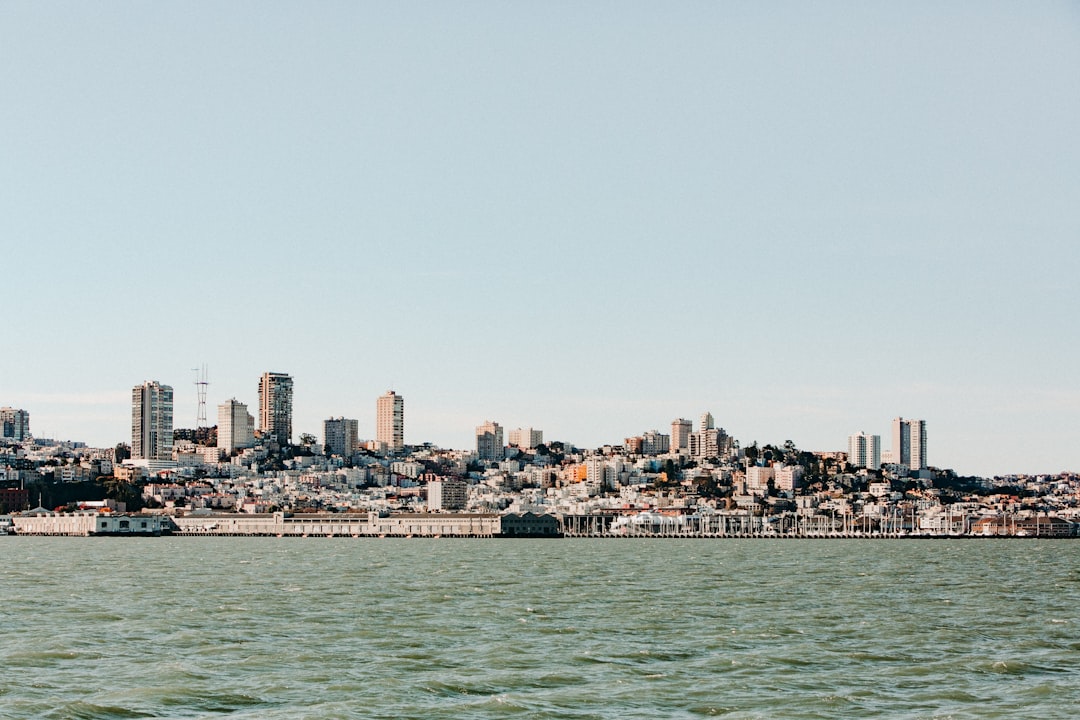 buildings across body of water under white sky