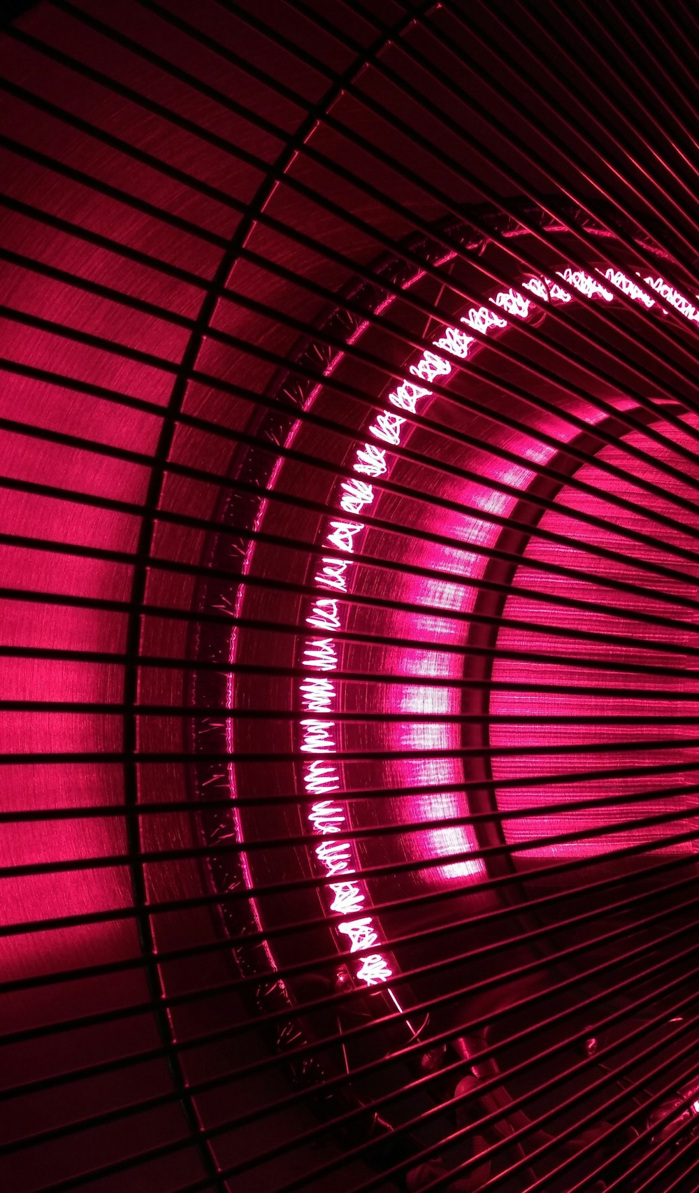 red LED lights seen through metal screen