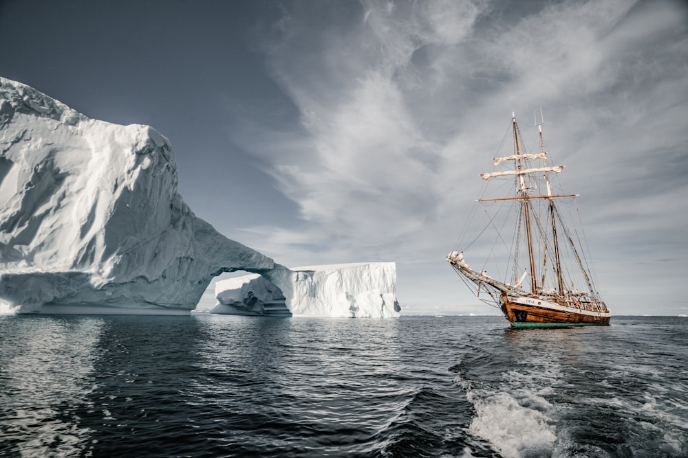 brown boat near glacier during daytime