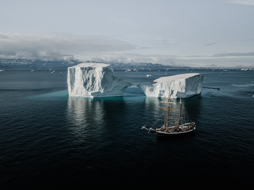 boat near ice glacier during daytime