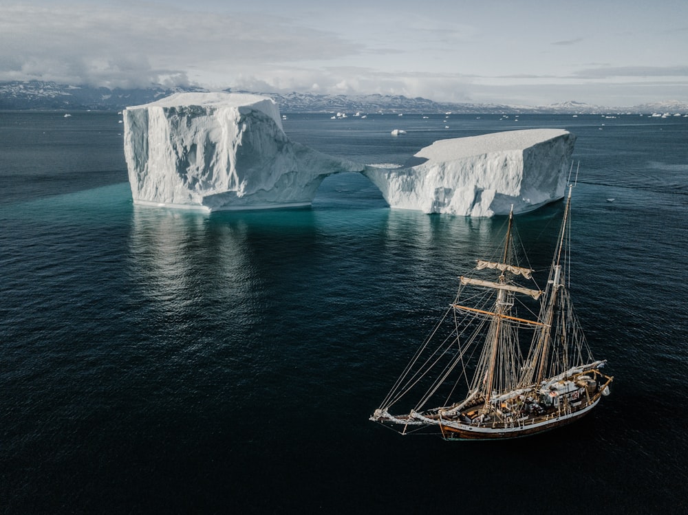 boat at sea near icebers during daytime