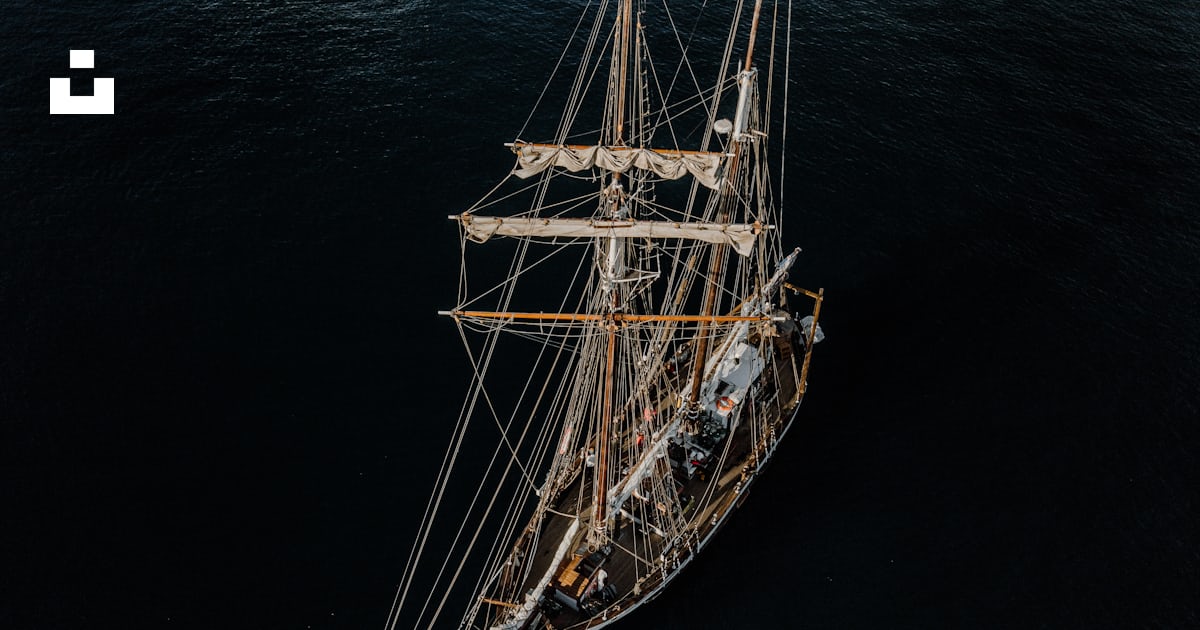 Boat with unwinded sails at sea during daytime photo – Free Grey Image ...