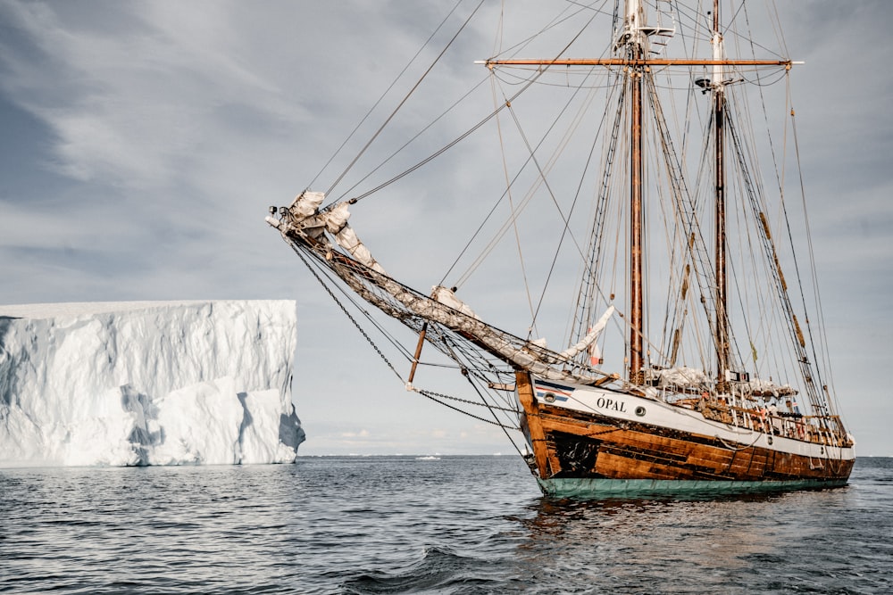 brown boat near glacier during daytime