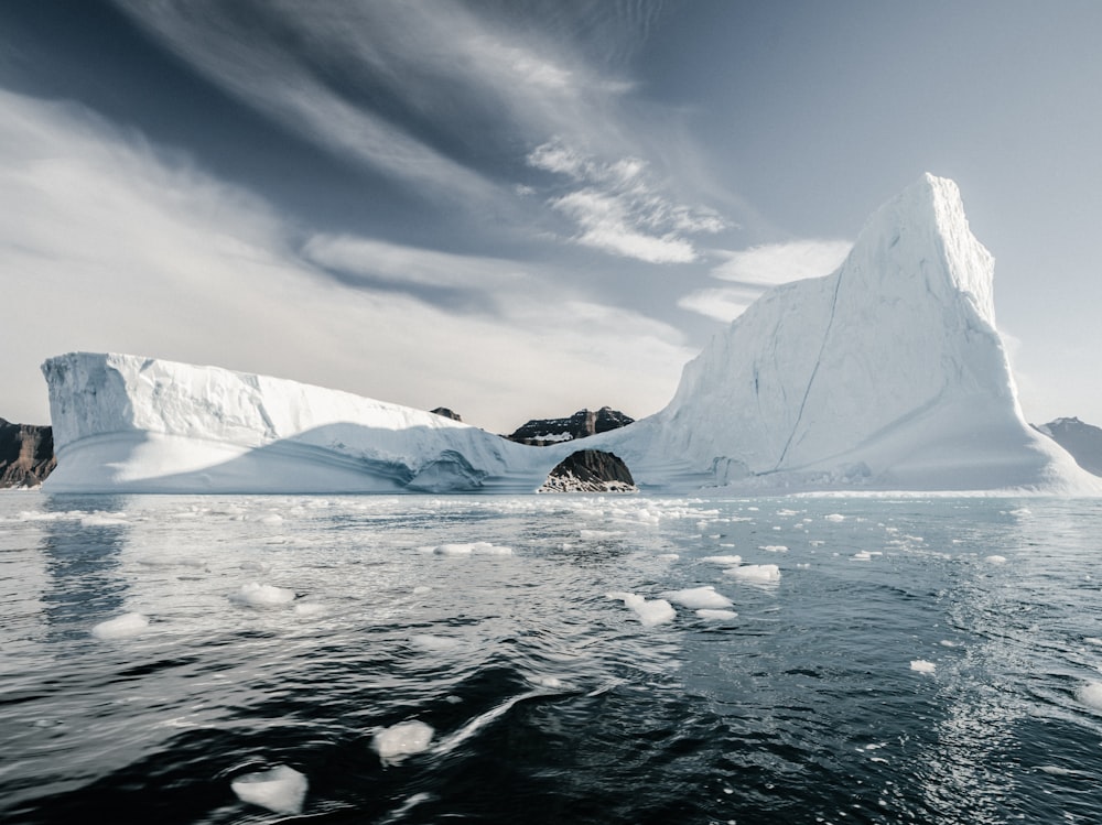 glacier surrounded by water during cloudy day