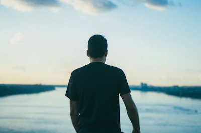 A serene image of a person looking thoughtfully at a sunrise, representing new beginnings and self-understanding.