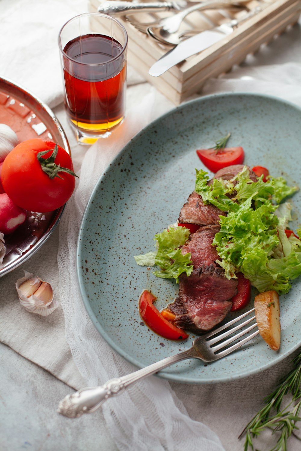 meat with sliced vegetables on plate