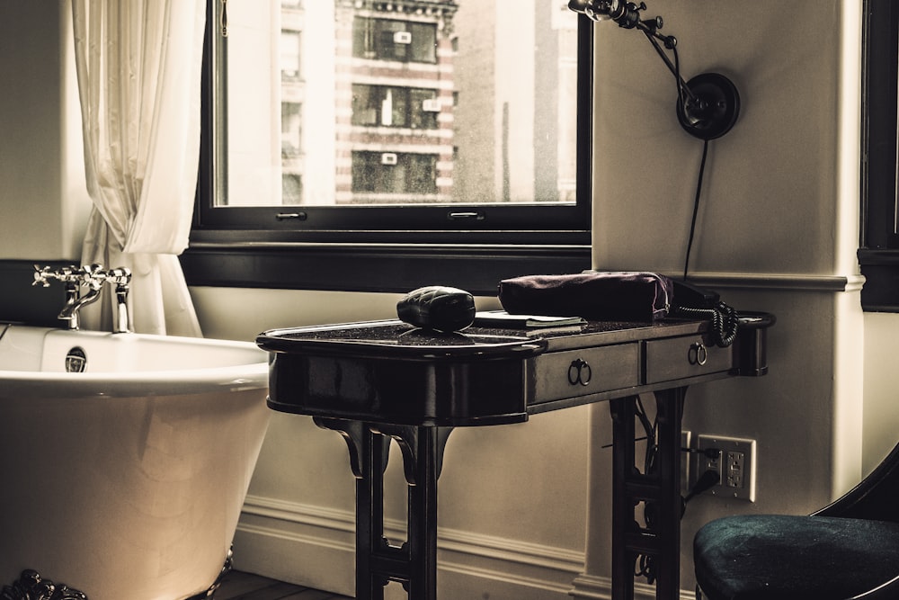 black wooden table near bathtub and wibdow