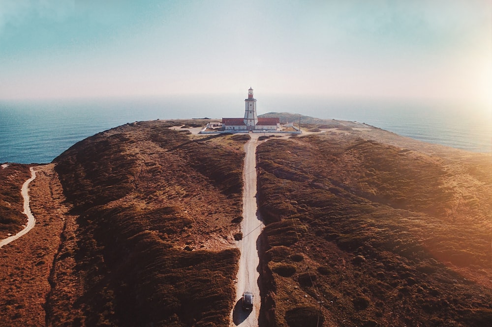 white lighthouse on hill