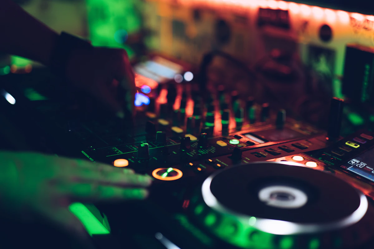 Hands working a DJ mixer