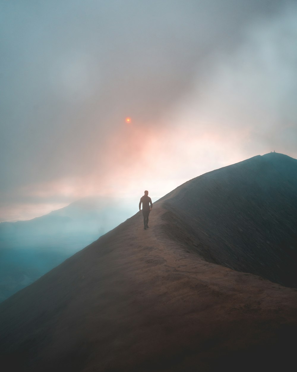 man walking on hill