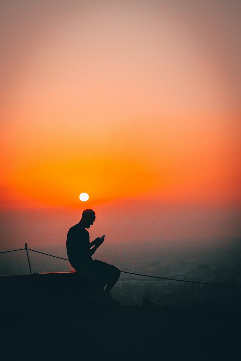 silhouette of man using smartphone