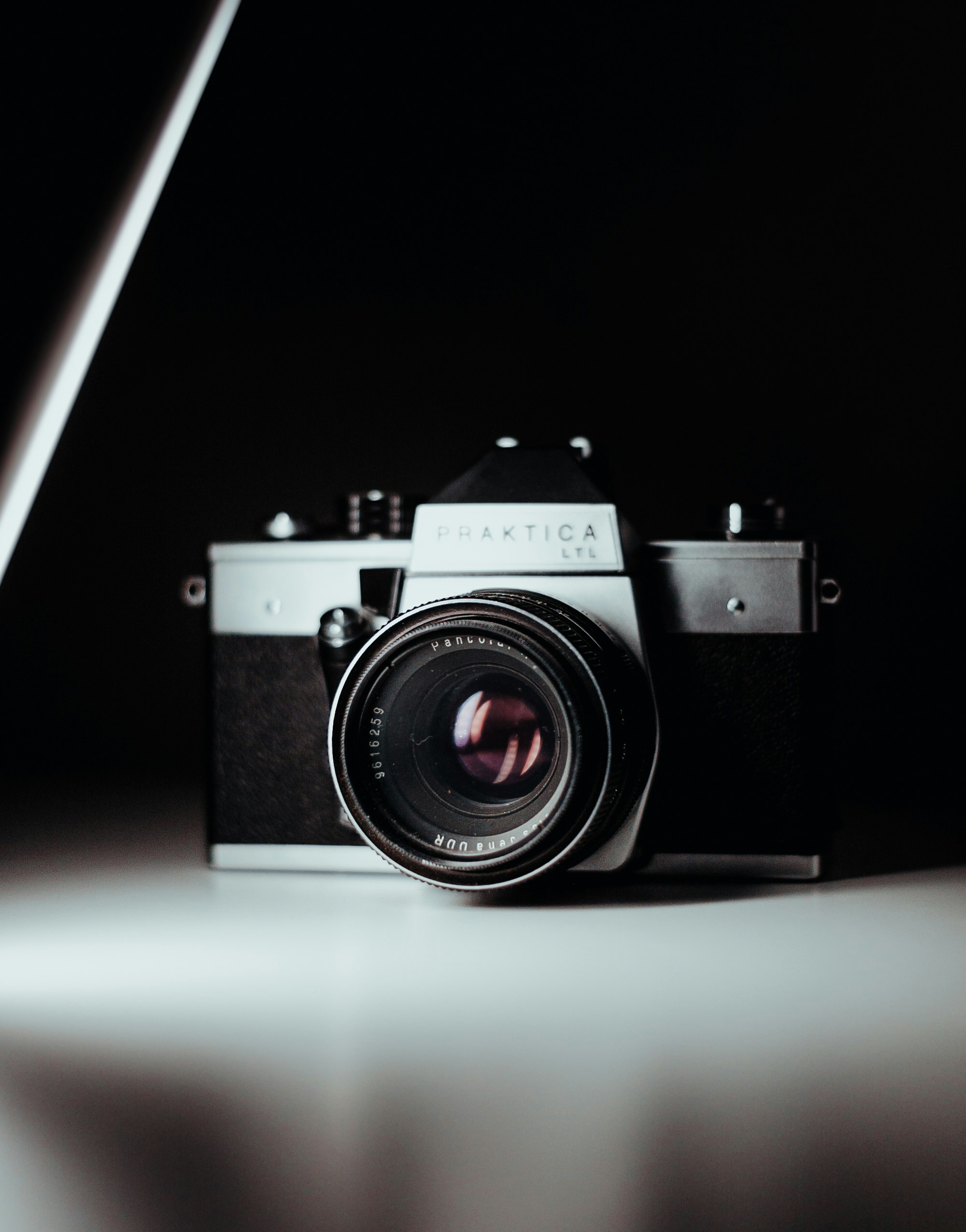 black and gray DSLR camera on white surface photo Free Camera Image