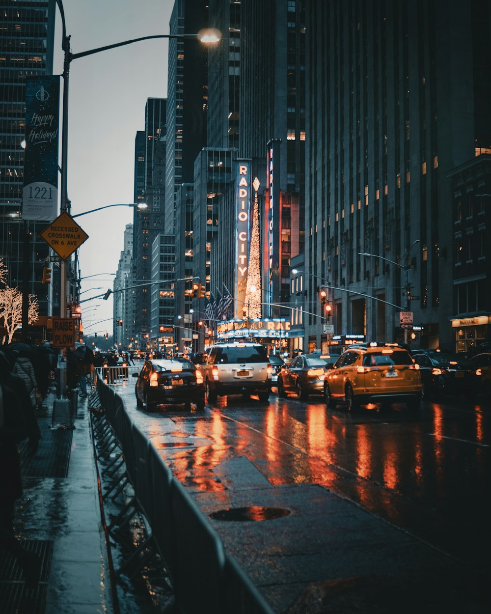 different cars on road near buildings during night time