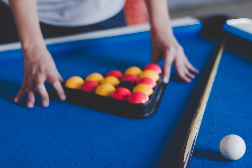 man preparing balls on pool table