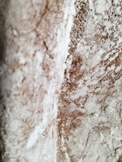 Close-up of the textured surface of carbon anti moisture powder under soft lighting.