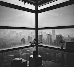 Elegant office with city skyline seen through a foggy glass window.