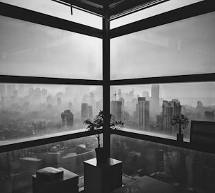 Elegant office with city skyline seen through a foggy glass window.
