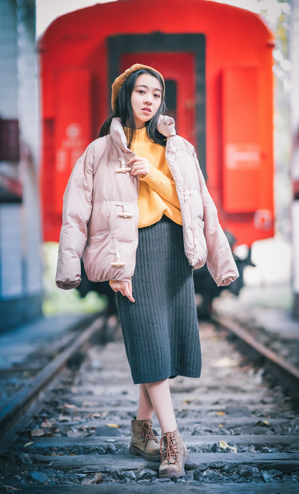 woman standing near red train