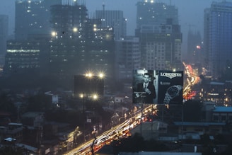 Billboards illuminated in a cityscape during twilight