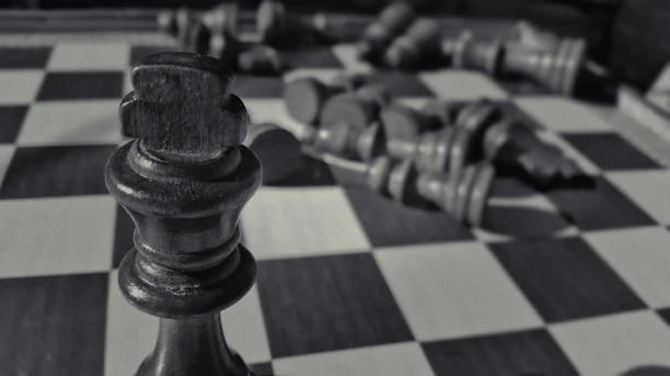 Close-up of a dark blue chess piece symbolizing strategic financial planning.