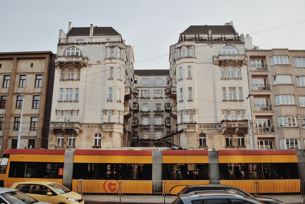 yellow bus near high rise building