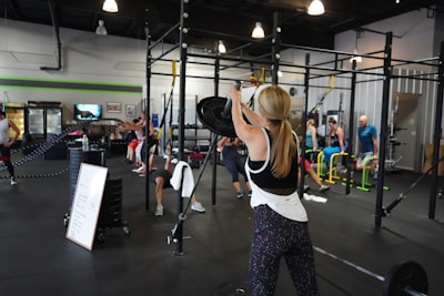 people doing exercise inside gym