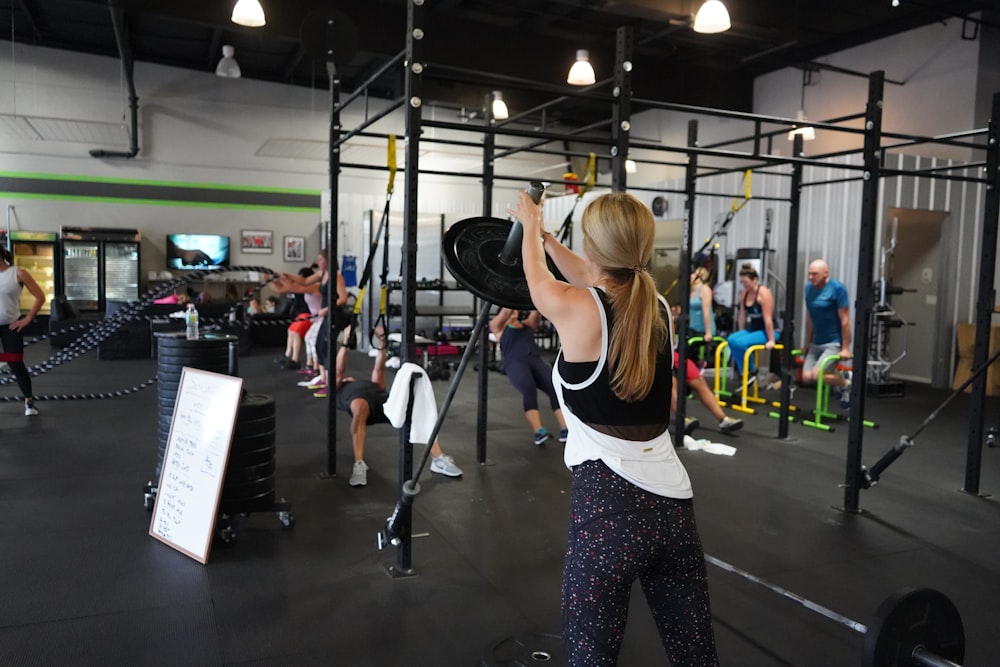 people doing exercise inside gym