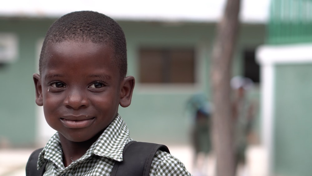 selective focus photography of boy wearing white collared shirt