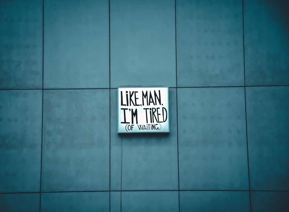 Like Man I'm Tired signage on blue surface