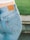 A satisfied customer showcasing their new jeans from Flashbuy.