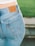 A happy customer wearing Majesty LLC jeans, showcasing a perfect fit.