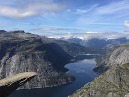 body of water between mountains at daytime