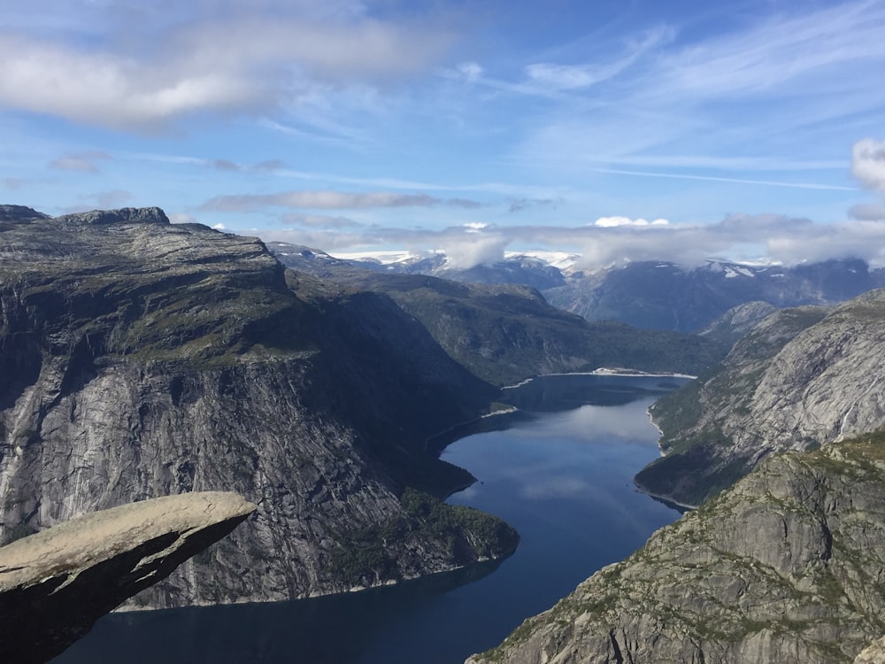 body of water between mountains at daytime