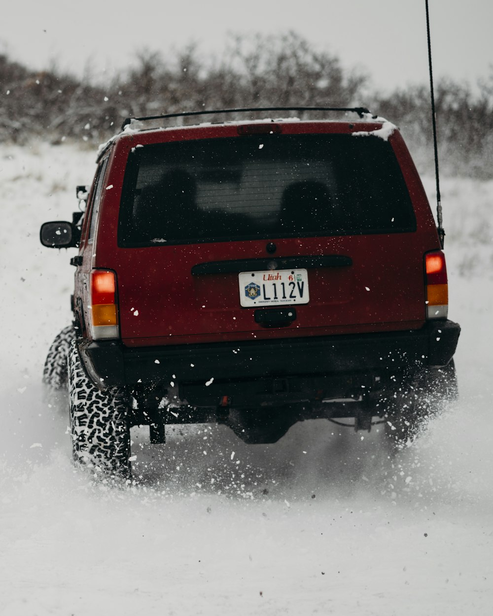 red SUV on ice covered tundra