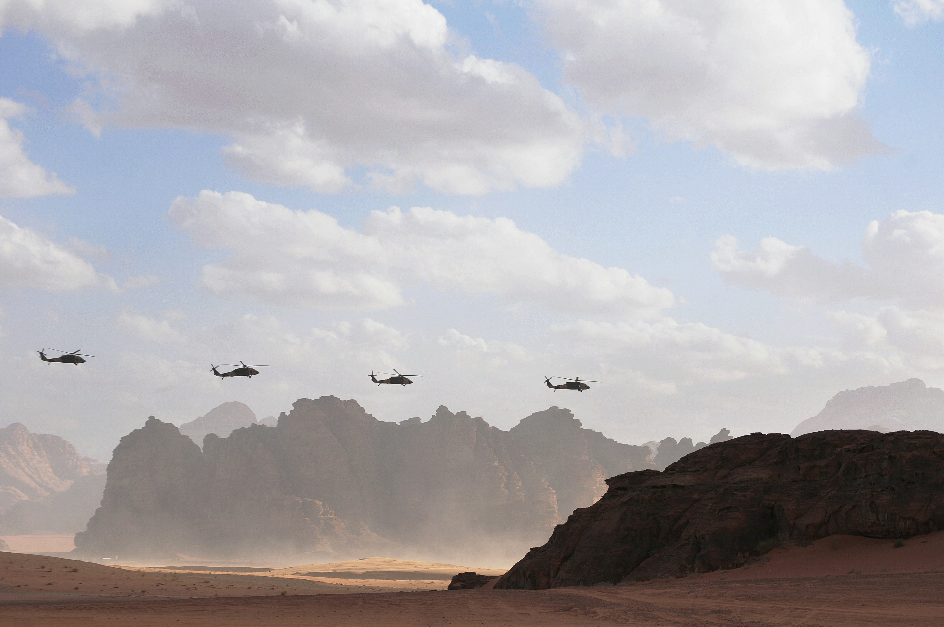 four helicopters in flight