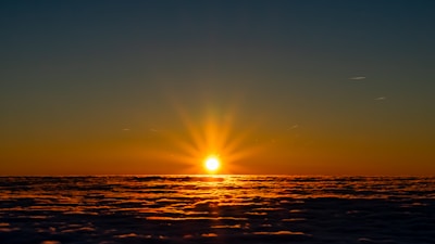 A vibrant sunrise over an ancient nebula, glowing with warm golden hues.