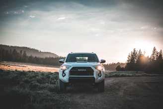 Sleek Toyota LC300 parked on a scenic Sri Lankan coastal road at sunset.