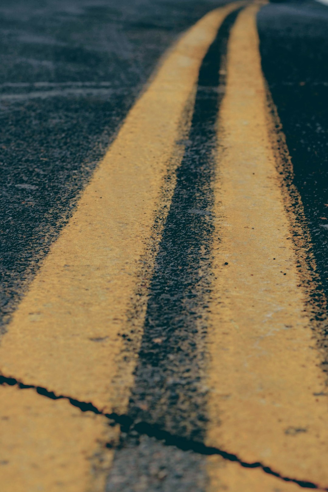 2 yellow stripes on paved road